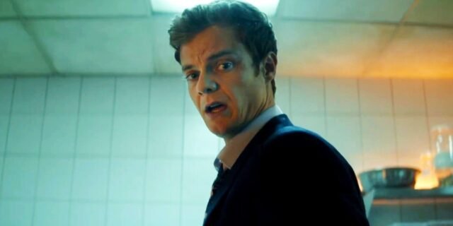 jack-quaid-looking-down-at-something-in-horror-in-novocaine.jpg